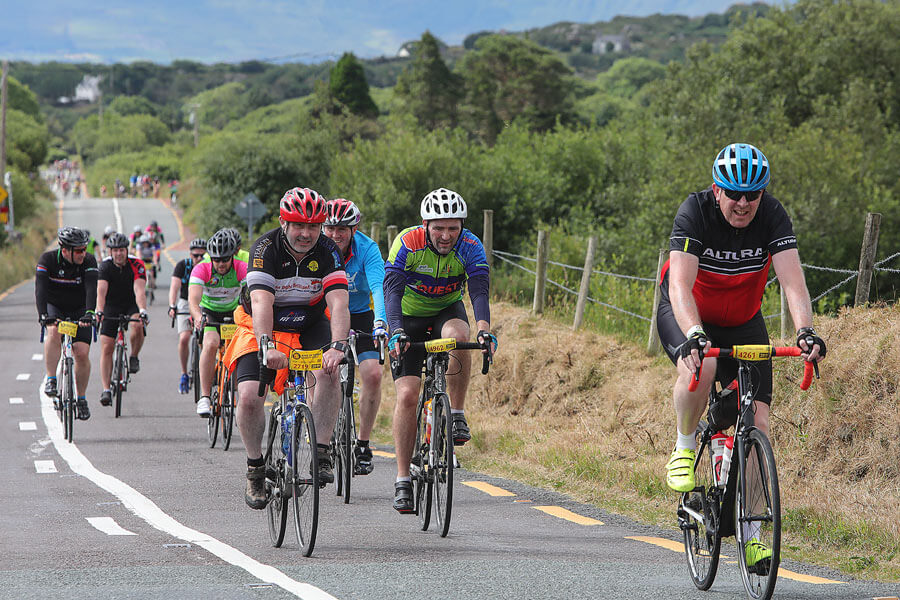 Cyclists enjoying a ride on a scenic road in the countryside near Killarney.