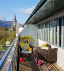 Balcony view at Park Place Apartments overlooking Killarney landscape and cathedral.