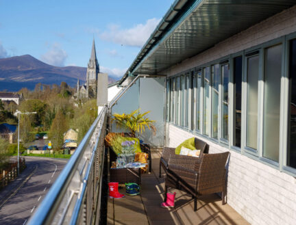 Balcony view at Park Place Apartments overlooking Killarney landscape and cathedral.