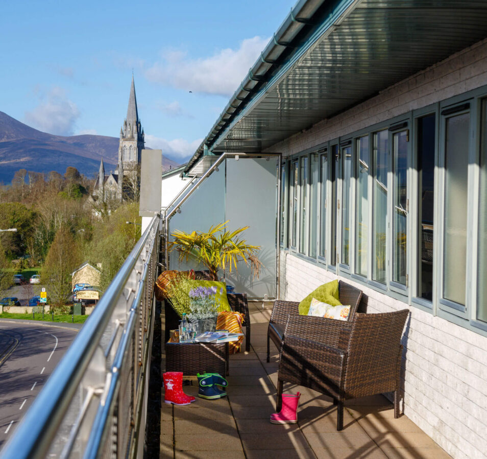 Balcony view at Park Place Apartments overlooking Killarney landscape and cathedral.