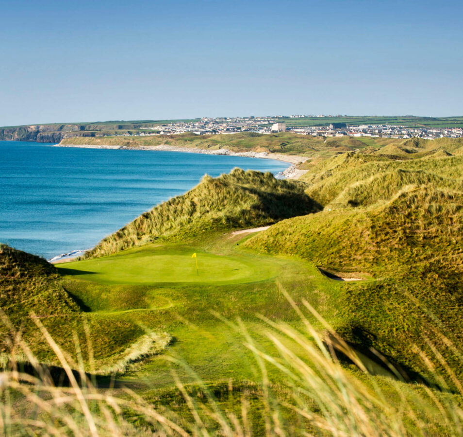 Coastal golf course with lush green fairways near Killarney, overlooking the sea.