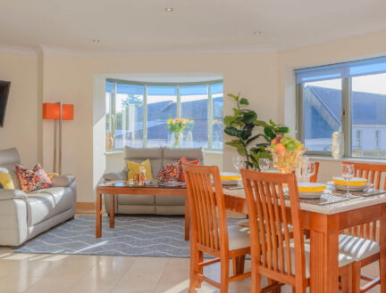 Spacious living dining area in Park Place Apartments, Killarney with comfy sofa and bright decor.