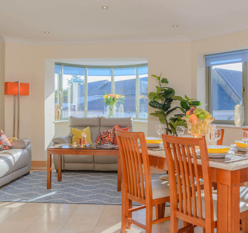 Spacious living dining area in Park Place Apartments, Killarney with comfy sofa and bright decor.