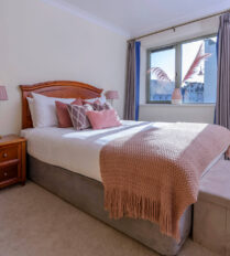 Cosy bedroom in Park Place Apartments, Killarney, with a plush bed and soft lighting.