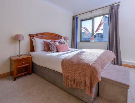 Cosy bedroom in Park Place Apartments, Killarney, with a plush bed and soft lighting.