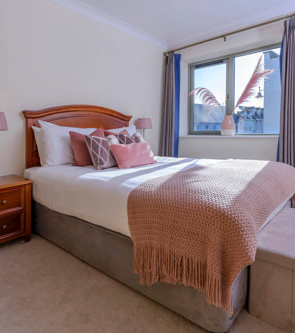 Cosy bedroom in Park Place Apartments, Killarney, with a plush bed and soft lighting.