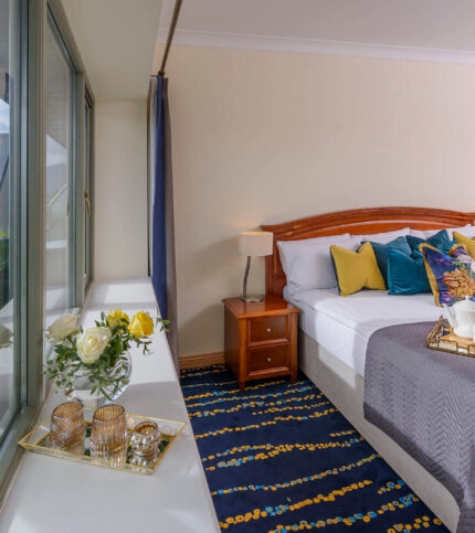 Cosy bedroom with mountain view at Park Place Apartments, featuring a breakfast spread.