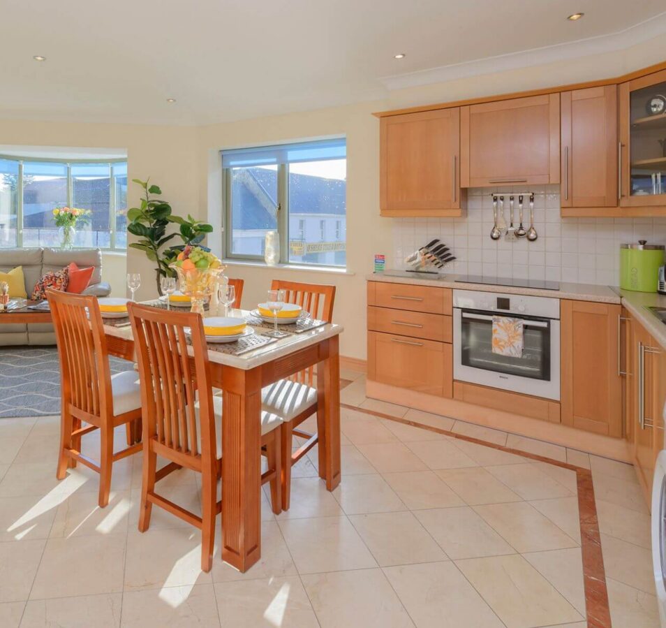 Bright, spacious kitchen and dining area at Park Place Apartments, Killarney, with a large window view.