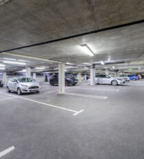 Spacious underground car park at Park Place Apartments in Killarney, well-lit with parked cars.