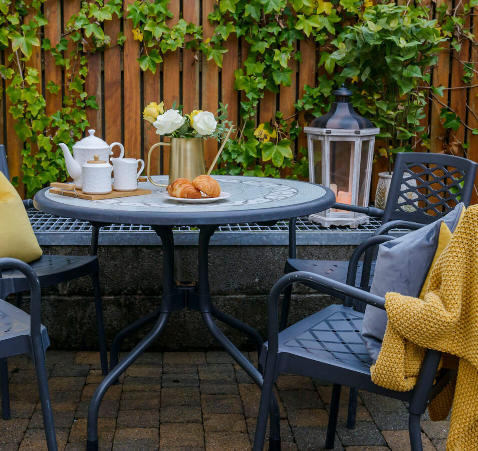 Cosy outdoor seating at Park Place Apartments with a tea set and croissants on the table.