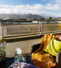 Cosy balcony at Park Place Apartments with mountain views and comfortable seating.