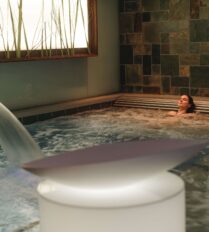A person relaxing in a modern jacuzzi at Park Place Apartments, Killarney.