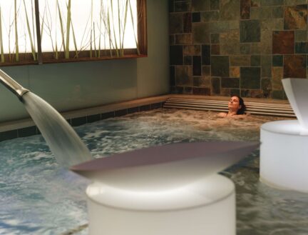 A person relaxing in a modern jacuzzi at Park Place Apartments, Killarney.