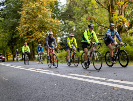 Cyclists enjoy a scenic ride through lush, green landscapes near Killarney.