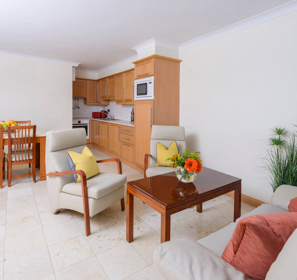 Spacious living area in Park Place Apartments, Killarney, with cosy seating and dining setup.