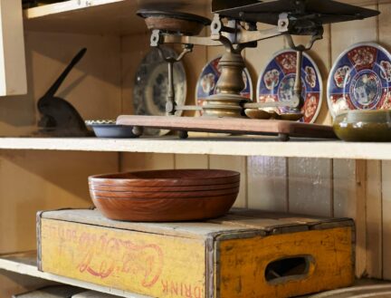Rustic shelves with vintage kitchenware and scales at Park Place Apartments.