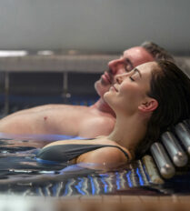 Couple relaxing in a hot tub at Park Place Apartments, Killarney.