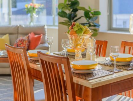 Bright, inviting dining area in Park Place Apartments with a table set for a family meal.