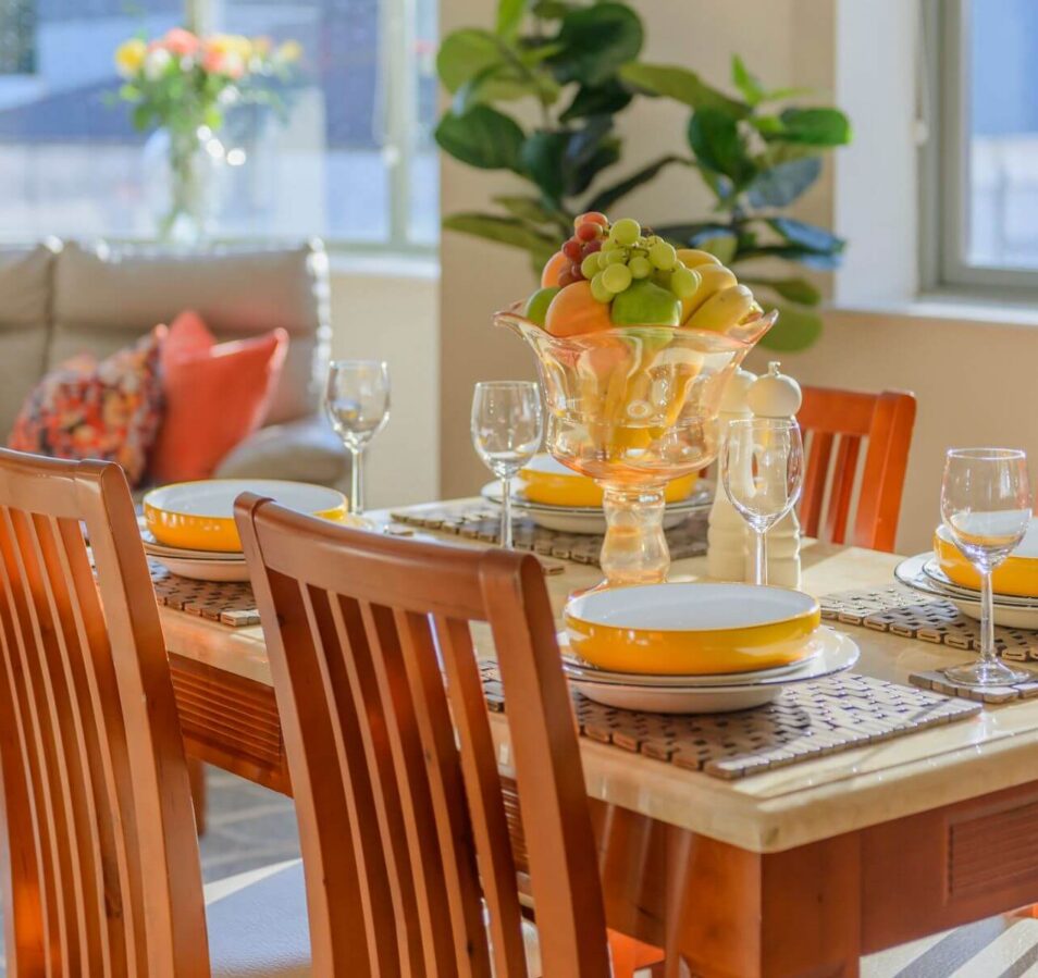 Bright, inviting dining area in Park Place Apartments with a table set for a family meal.