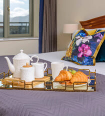 Elegant bedroom with breakfast tray at Park Place Apartments, Killarney.