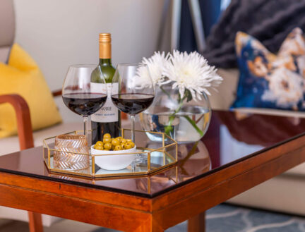 Comfortable living room with wine, flowers, and snacks at Park Place Apartments.