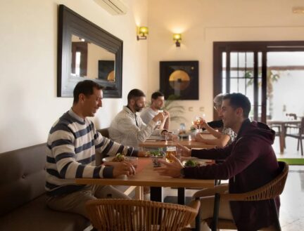 A family enjoying a meal in a cosy dining area at Park Place Apartments, Killarney.