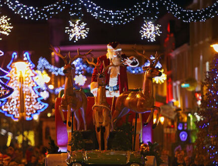 Family enjoying festive Christmas lights display in Killarney town centre.