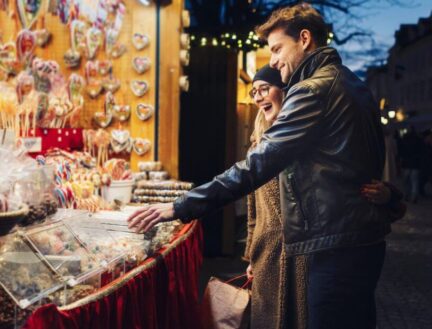 A couple enjoys shopping at a festive market stall in Killarney town.